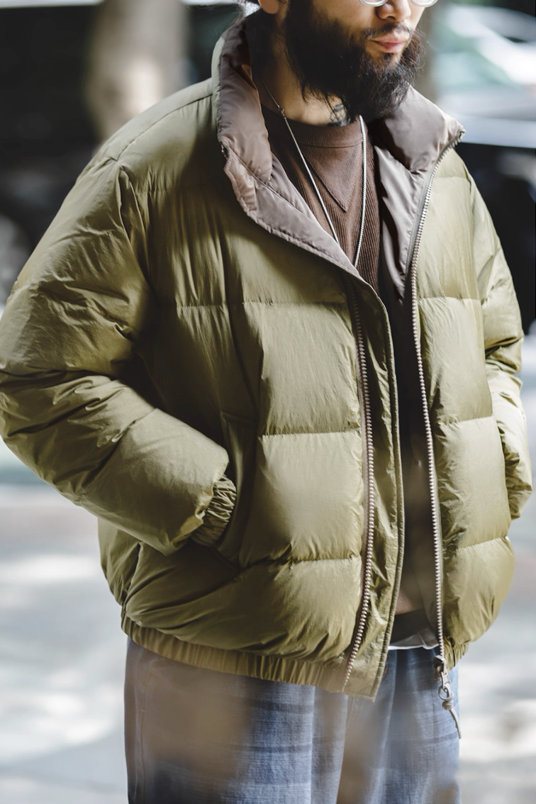 Side view of model in army green Reversible Down Jacket showing smooth B-side finish