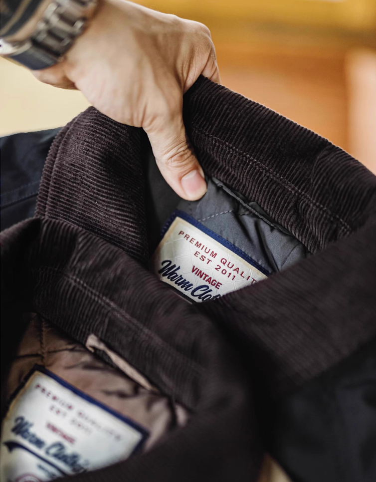 Close-up of corduroy collar label showing premium craftsmanship