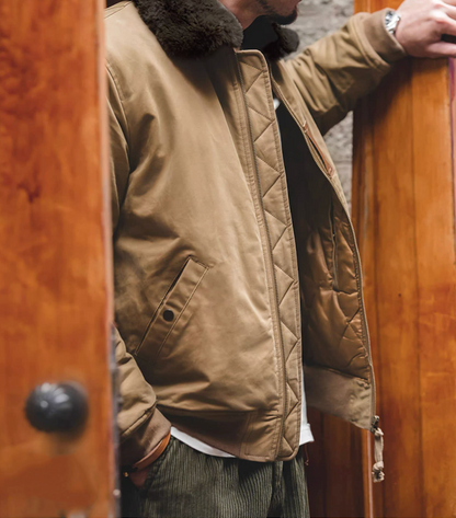 Khaki B-15 bomber jacket half-unzipped showing inner lining and texture