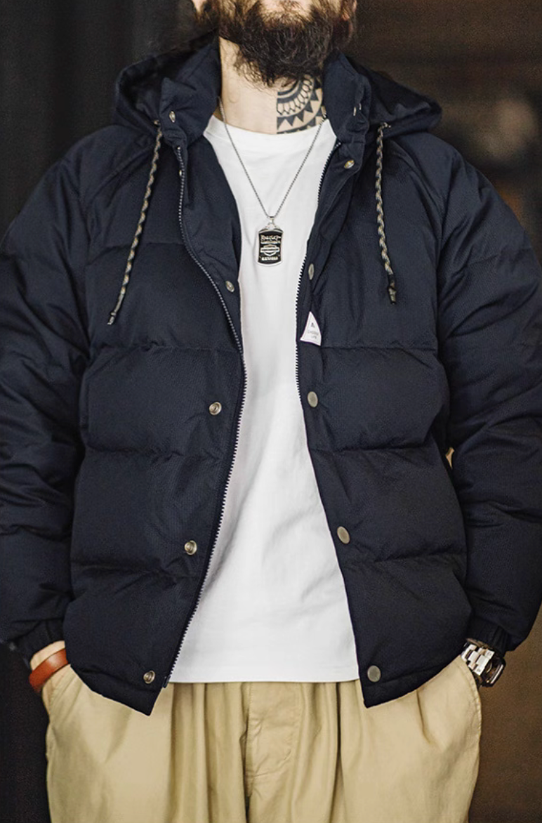 Model wearing dark blue Urban Shield Down Jacket over white tee