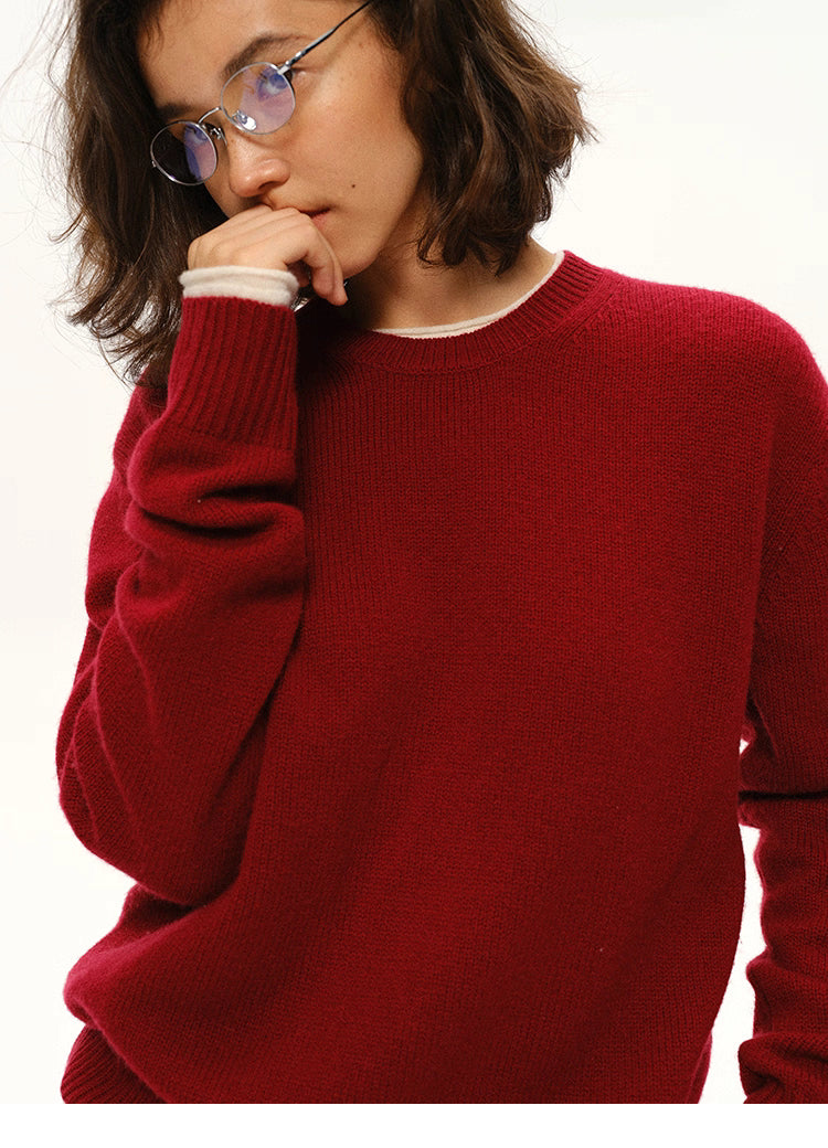 Close-up of wine red cashmere-blend sweater with model in a thoughtful pose.