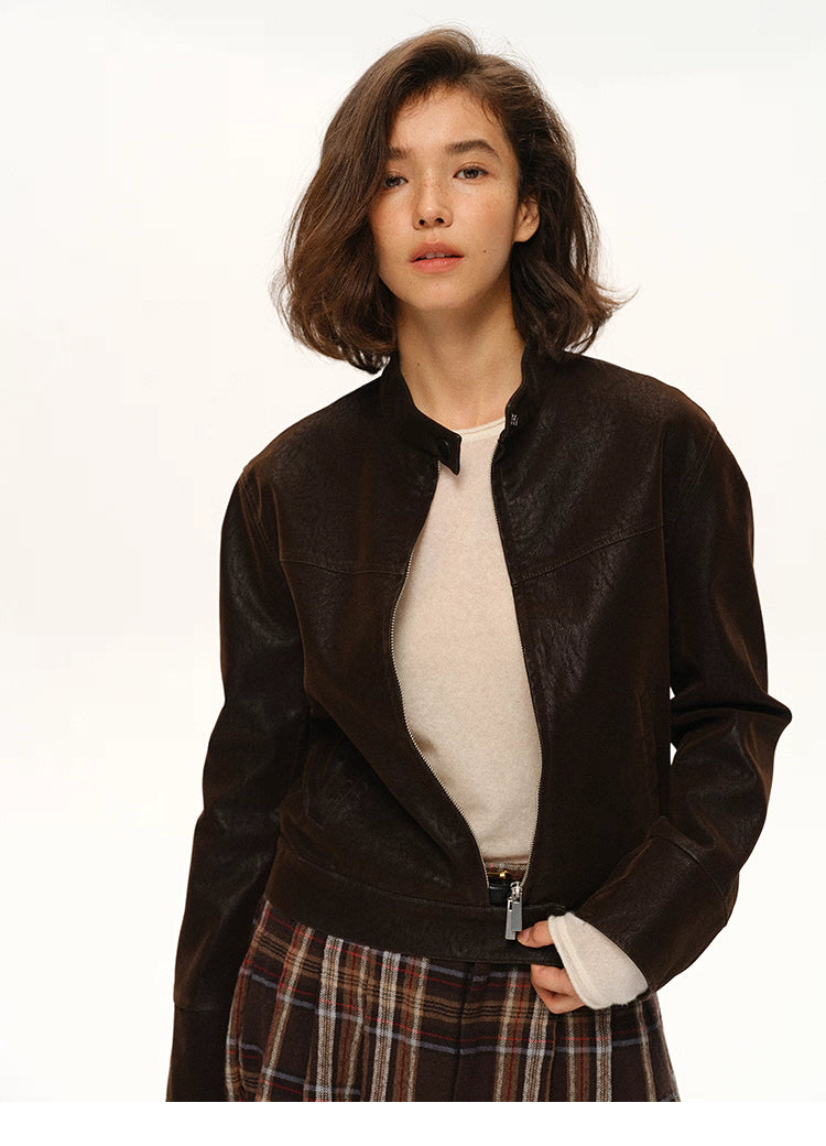 Cocoa faux-suede moto jacket shown open from the front, highlighting stand collar and cropped length.