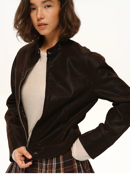 Side-angle close-up of cocoa suede-look moto jacket showing texture and clean collar design.

