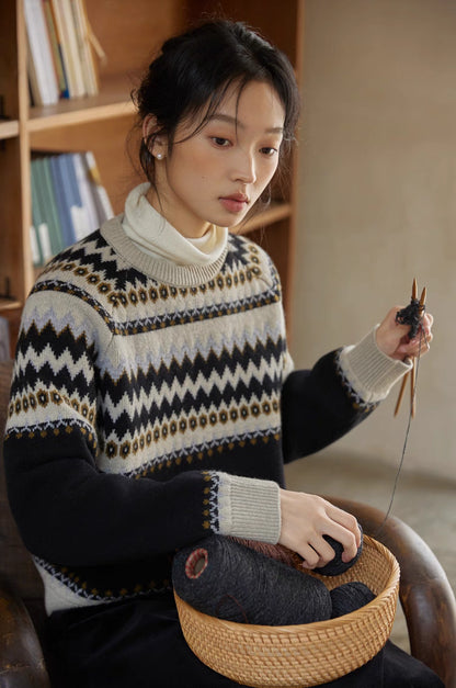 Model knitting in black-cream Fair Isle wool sweater near bookshelf