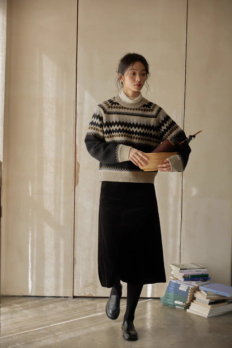 Full-body shot, model wearing black-cream Fair Isle sweater with black skirt