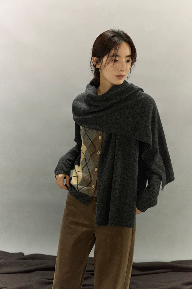 Model styled with matching dark gray scarf layered over argyle cardigan for winter look