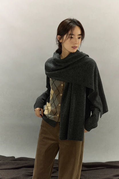 Model styled with matching dark gray scarf layered over argyle cardigan for winter look