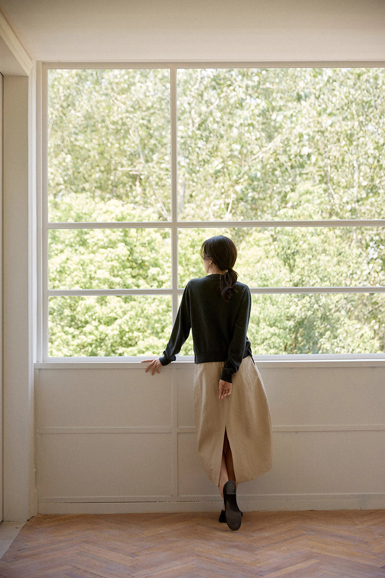 Model showcasing back design and soft wool texture under natural light