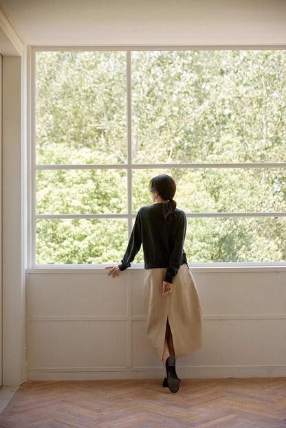 Model showcasing back design and soft wool texture under natural light