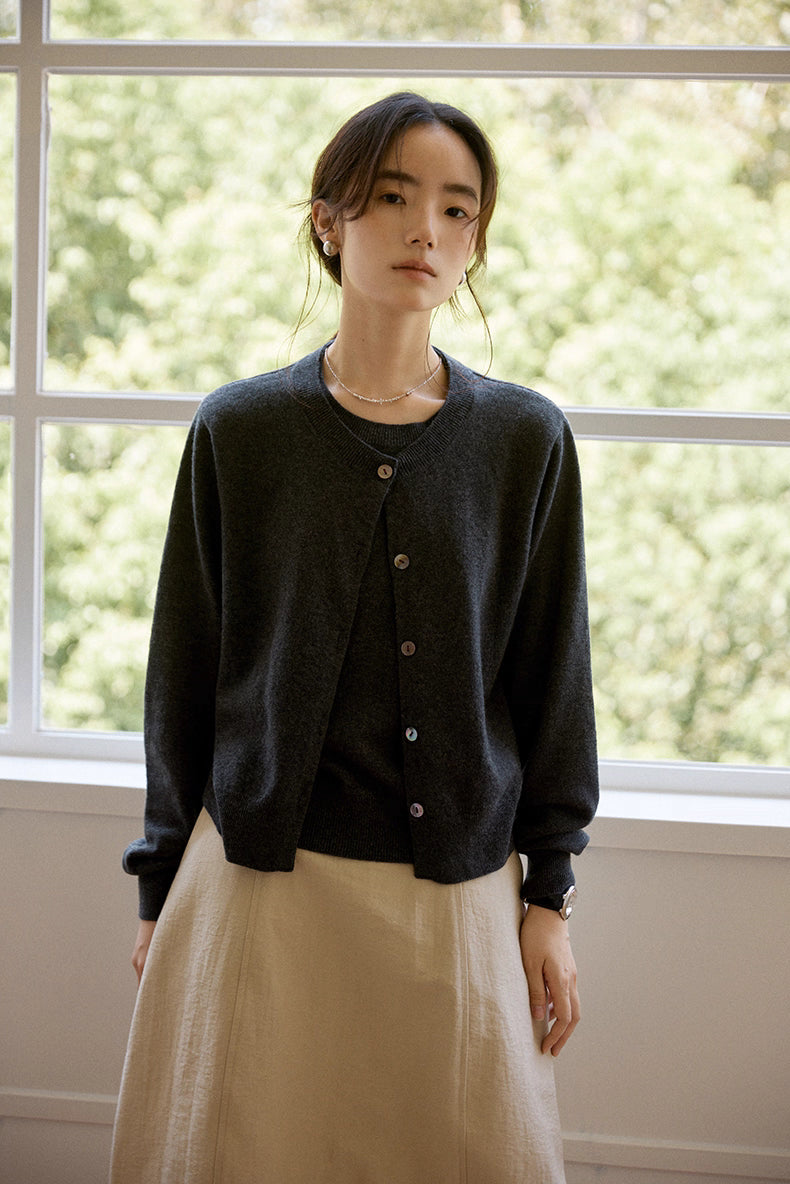 Model wearing ColorfulWorld Heritage Wool Twin-Layer Cardigan in dark gray, front view by window