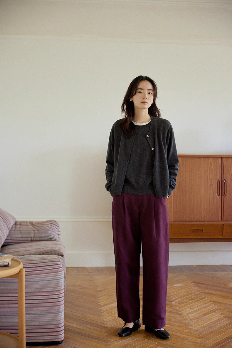 Minimalist home scene featuring dark gray merino wool cardigan outfit