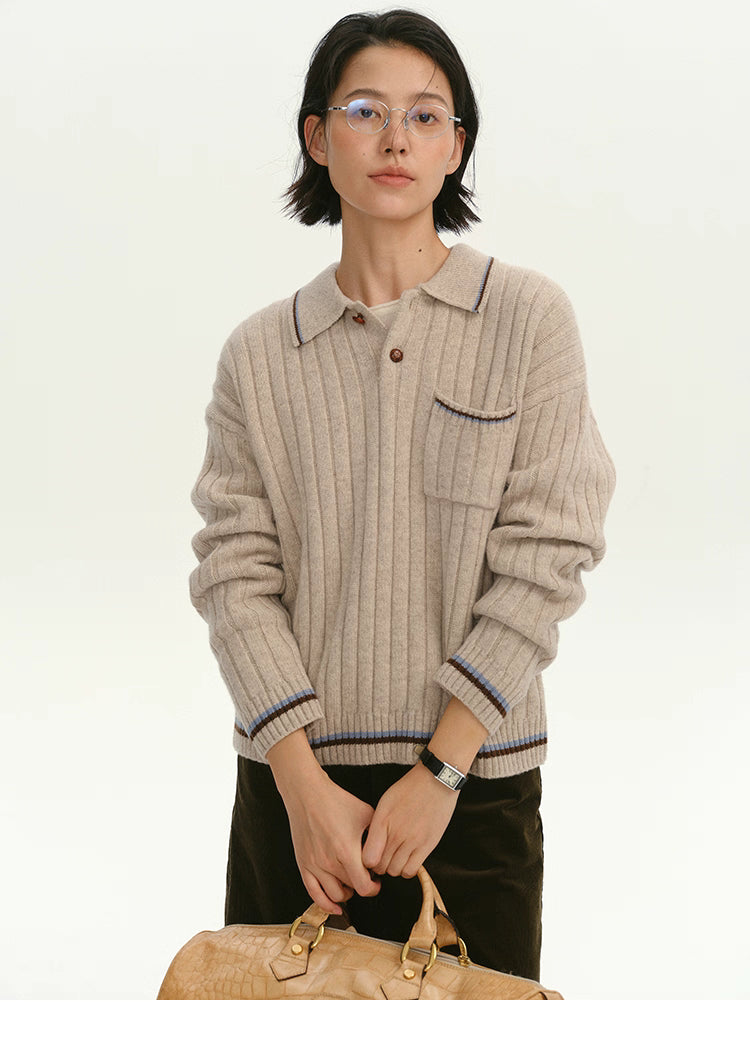 Woman wearing a light camel ribbed wool polo sweater, front view with contrast trim.