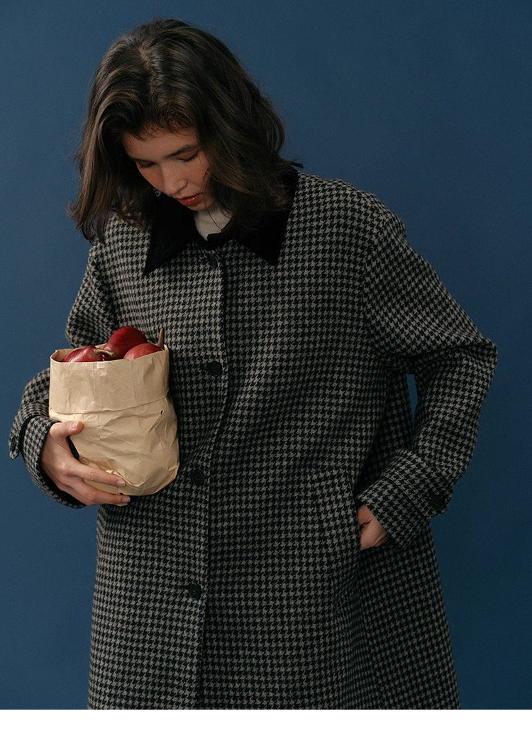 Close-up of soft corduroy collar and midnight houndstooth wool texture as the model holds apples.