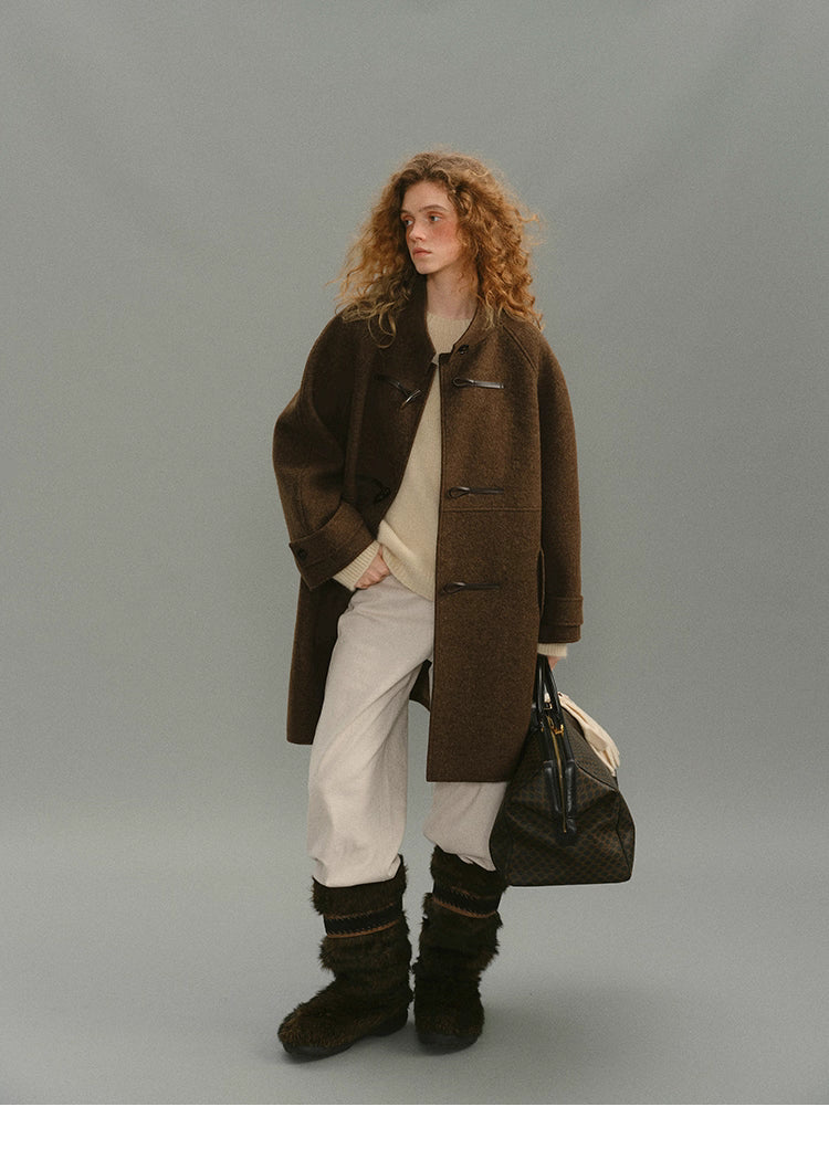 Full-body view of brown alpaca-wool toggle coat with winter outfit.