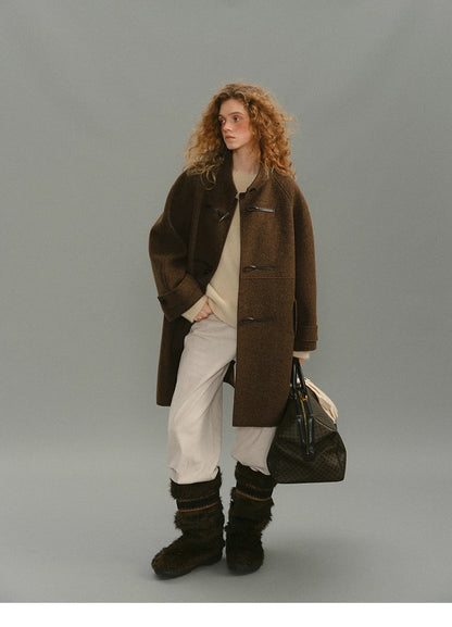 Full-body view of brown alpaca-wool toggle coat with winter outfit.