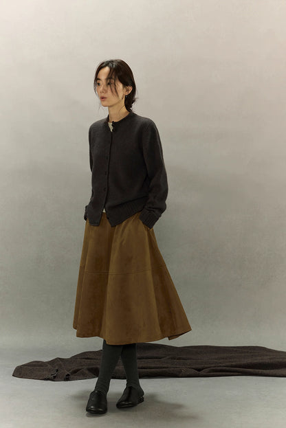 Angled front view of charcoal yak wool cardigan outfit, showing relaxed winter layering with brown skirt