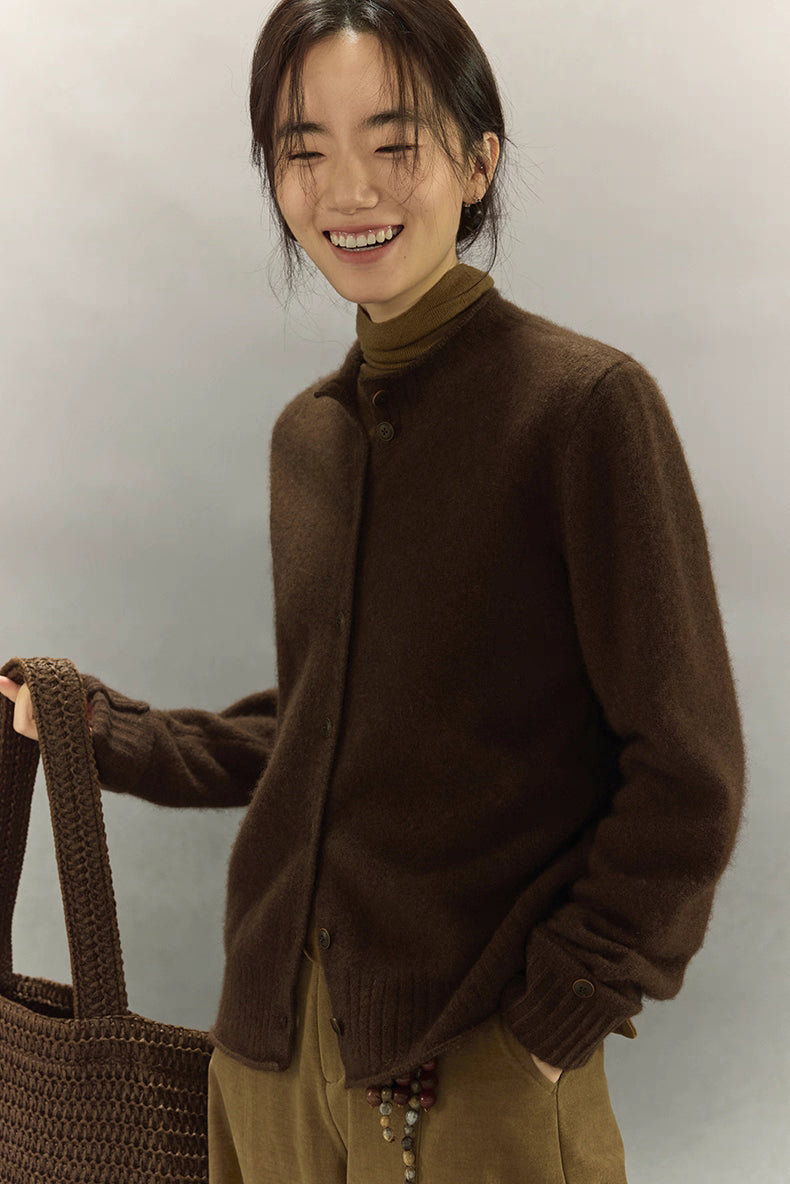 Soft yak wool dark coffee cardigan styled with brown turtleneck and woven tote bag, model smiling
