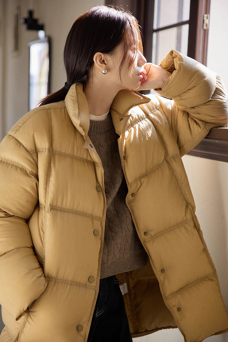 Close-up of caramel brown Cloud-Contour Down Coat showing horizontal quilting, snaps and soft texture