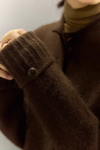 Close-up of ribbed cuff and button detail on dark coffee yak wool cardigan sleeve
