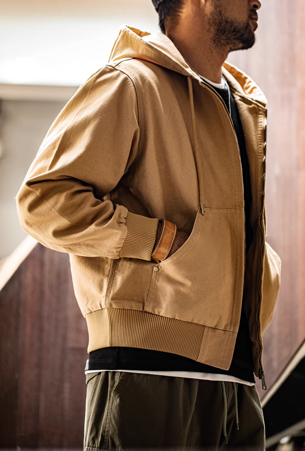Side view of Khaki Adventure Ready Hooded Jacket worn by model showing pocket opening, ribbed cuff and soft cotton texture