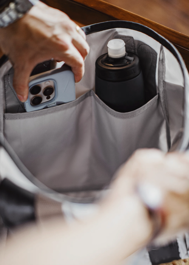 Interior compartments showing phone and bottle storage of water-resistant tote