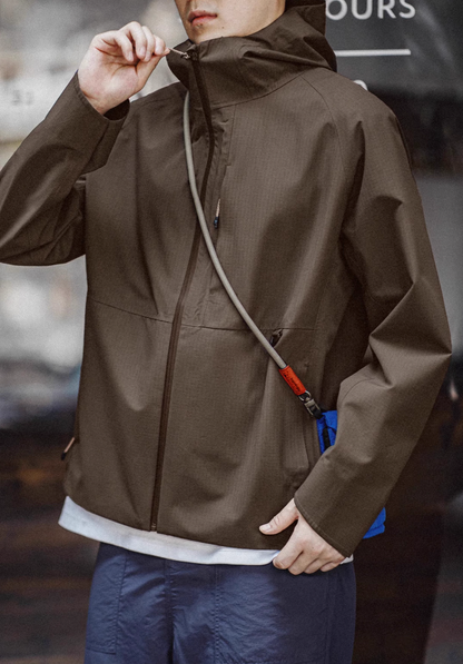 Khaki ripstop shell coat with high-neck zip closure showing windproof protection and lightweight everyday outdoor wear