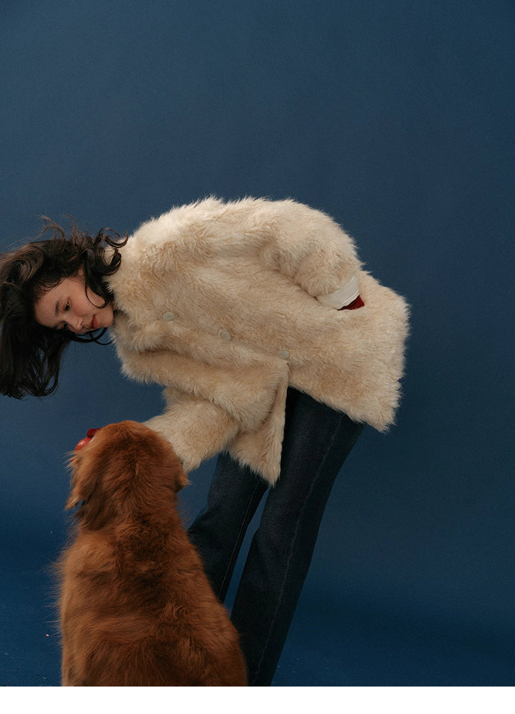 Model in Almond Aura Plush Coat bending to interact with golden-brown dog