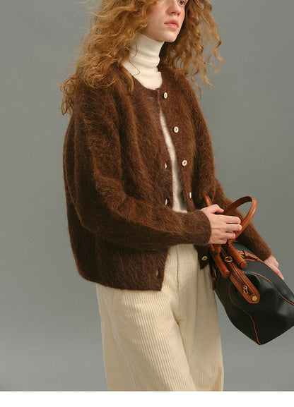Side view of Deep Caramel Brown alpaca cardigan paired with structured leather bag