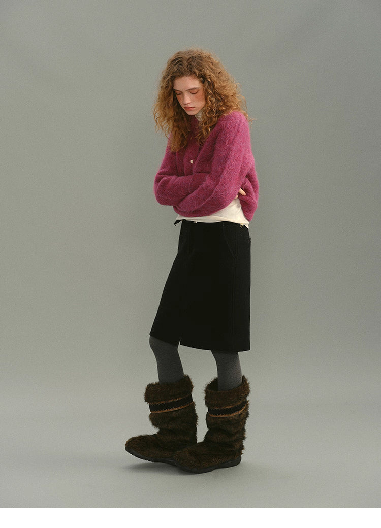 Full-body view of Rose Plum alpaca cardigan styled with black skirt and winter boots