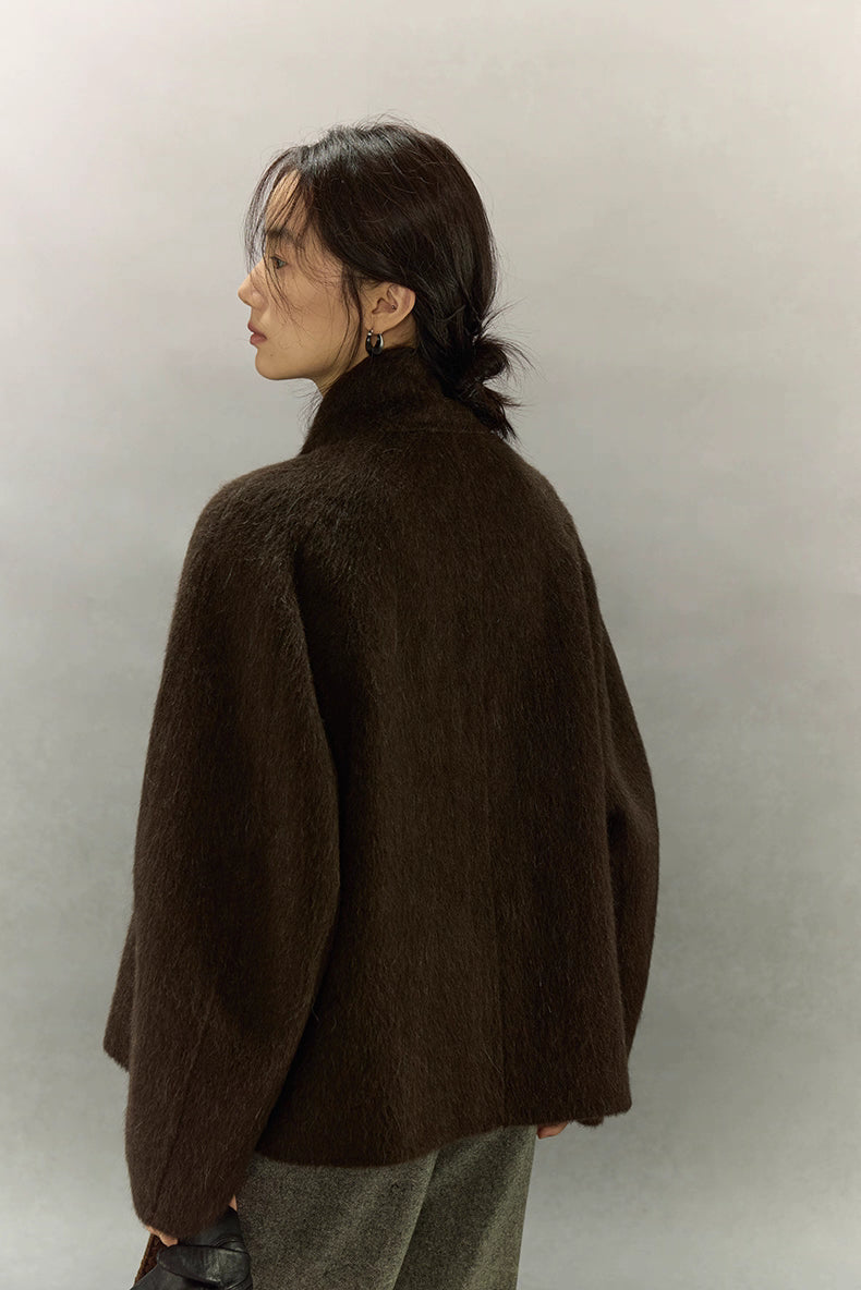 Back view showing smooth drape of dark coffee brown alpaca short jacket
