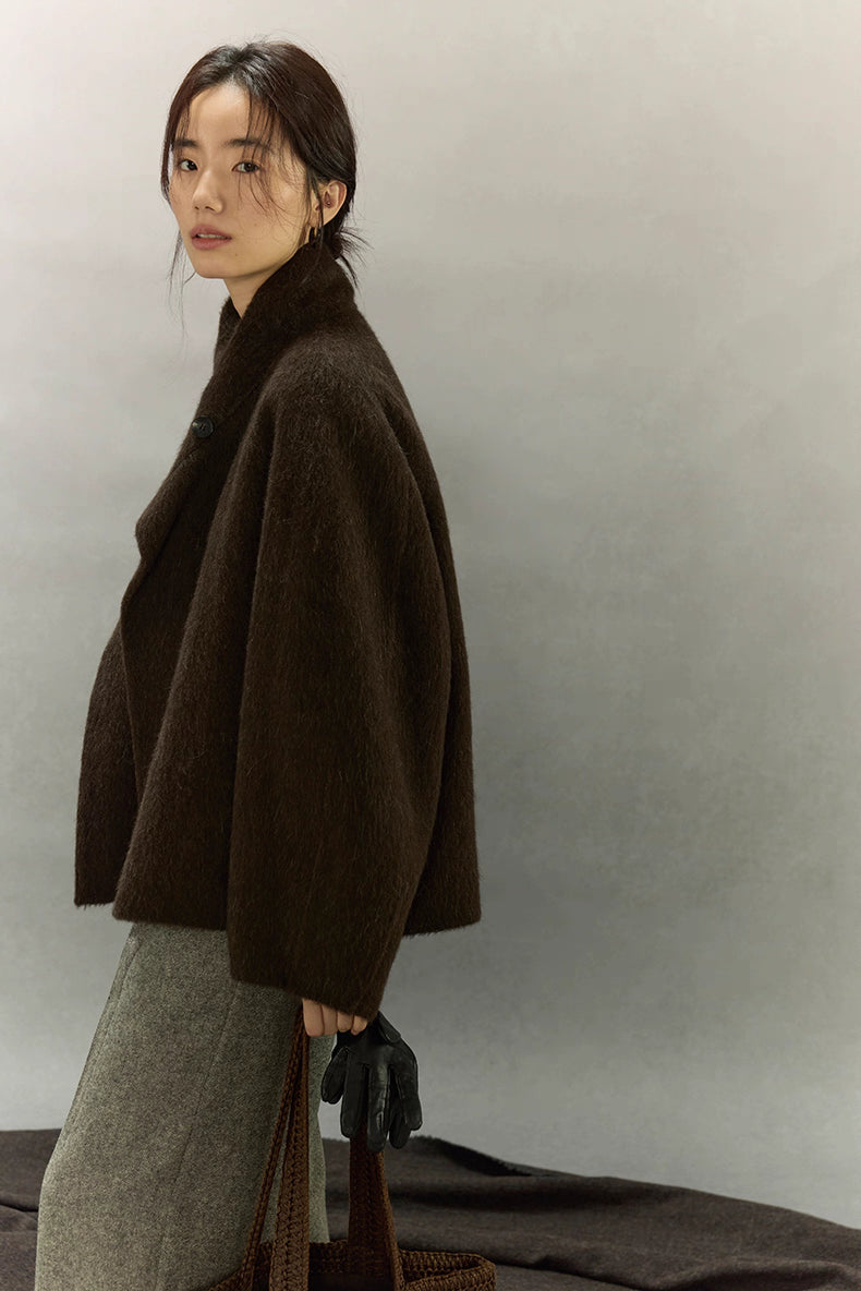 Side profile of dark coffee brown alpaca jacket with relaxed sleeves and collar