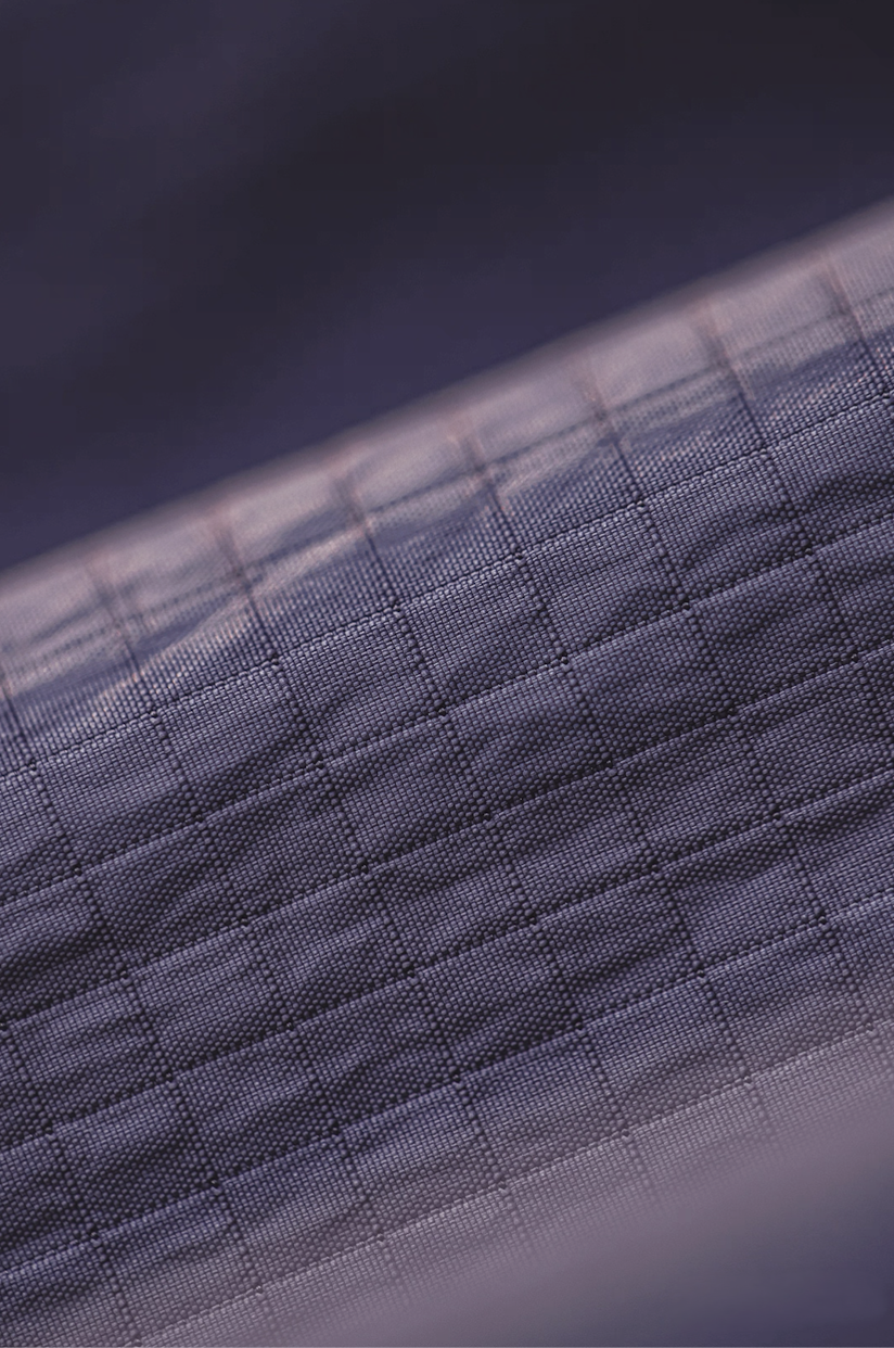 Close-up detail of dusty purple geometric grid nylon fabric texture