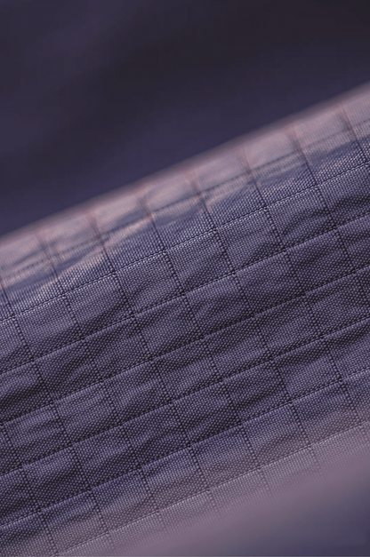 Close-up detail of dusty purple geometric grid nylon fabric texture