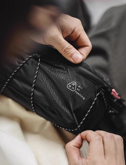 Close-up of AON “All or Nothing” logo on black diamond-grid fabric