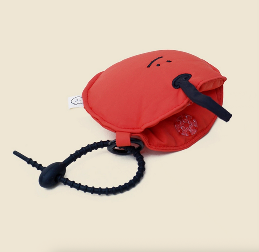 Red apple face mini pouch keychain open, showing zipper storage.