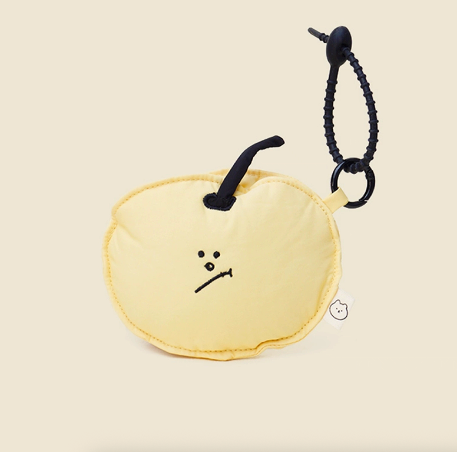 Yellow apple face pouch keychain with expressive embroidered design.
