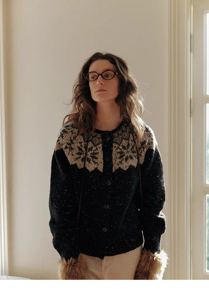 Black aran knit cardigan with fair isle yoke pattern front view showing button closure and relaxed fit