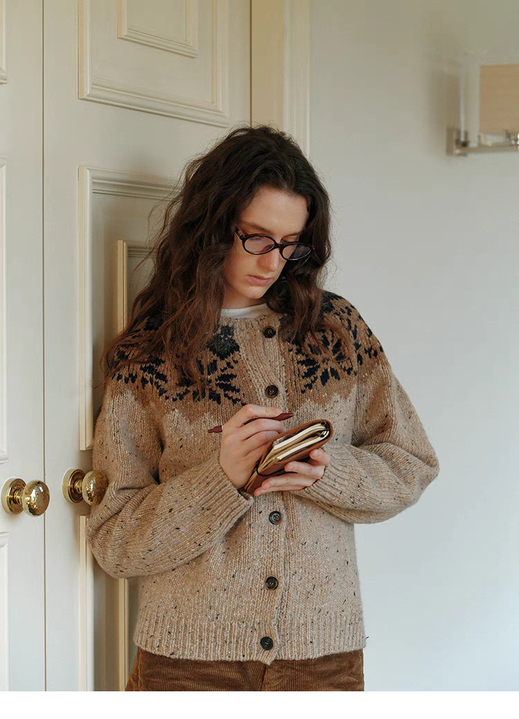 Khaki cable knit cardigan lifestyle shot writing in notebook highlighting soft texture and relaxed silhouette
