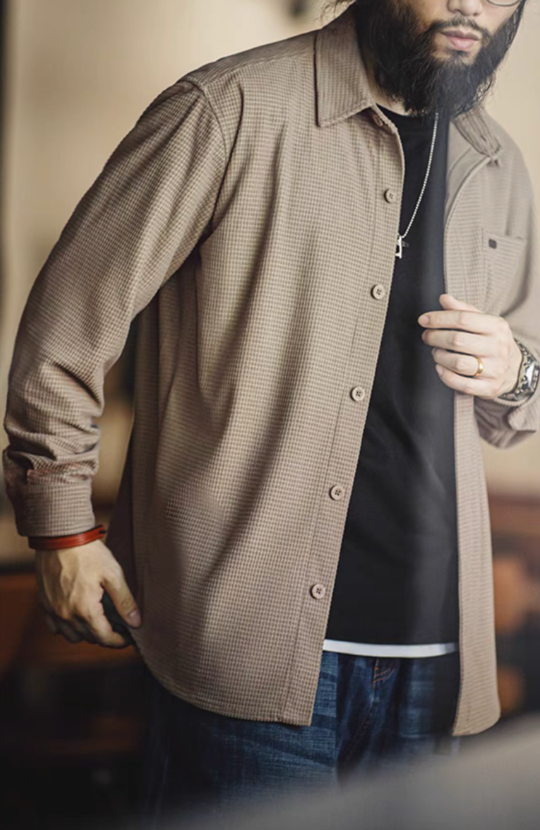 Camel textured long sleeve shirt styled over black tee showing side angle fit, structured fabric, and vintage-inspired design