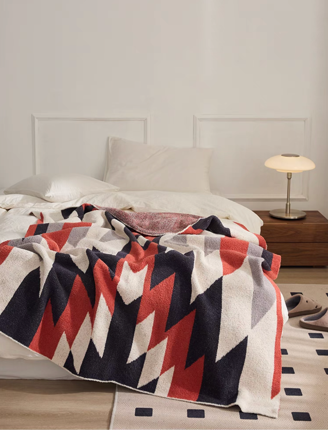 Dawn Red blanket spread on bed with tea cup and magazine creating warm and inviting bedroom scene