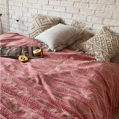 ArcWeave linen cotton handloom throw blanket in red color draped across bed with woven arc pattern and neutral decorative pillows