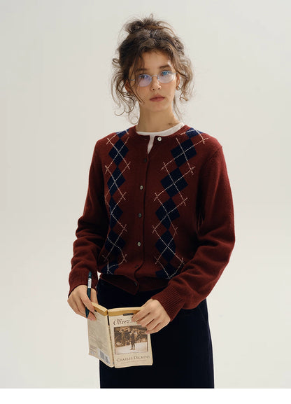 model standing wearing wine red argyle wool cardigan holding book