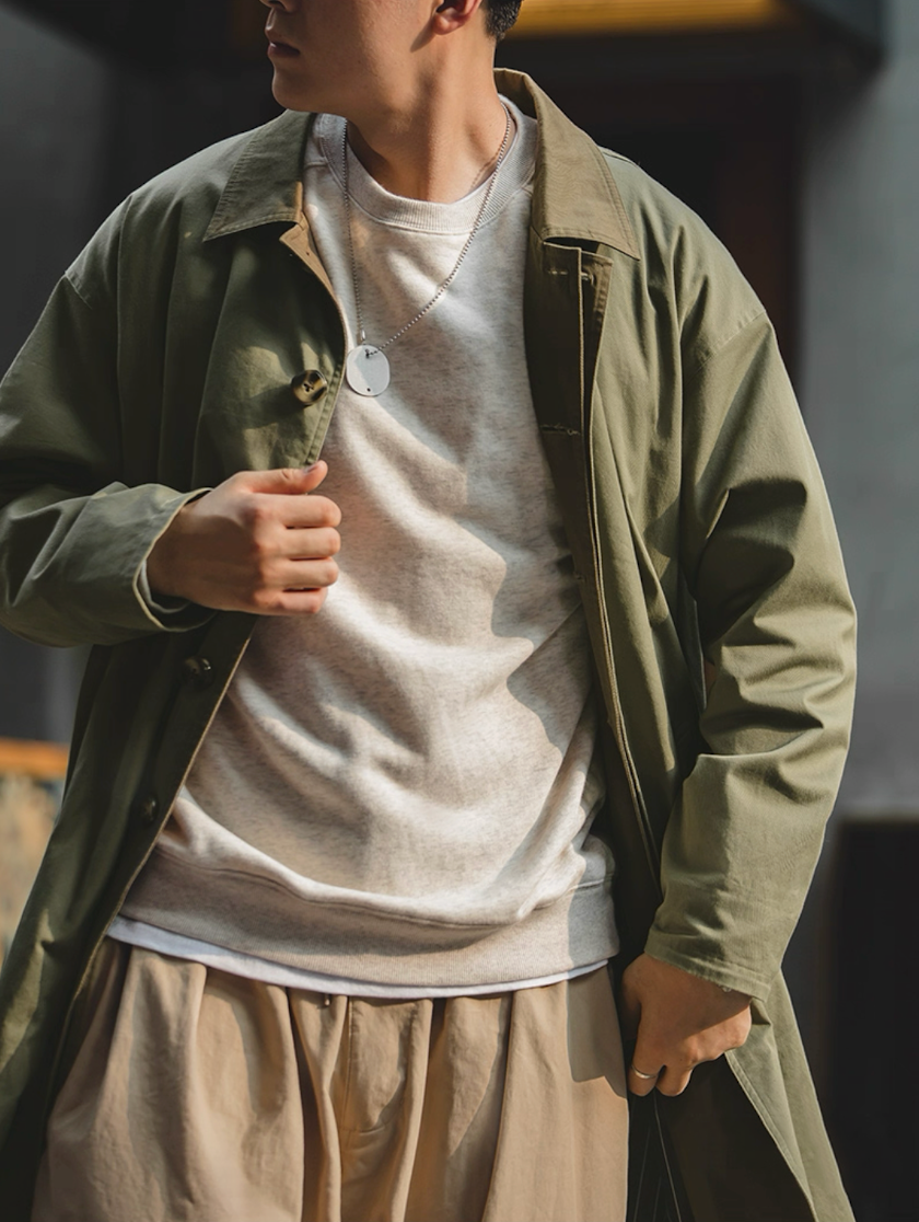 Model wearing army green coat with sweater and pants
