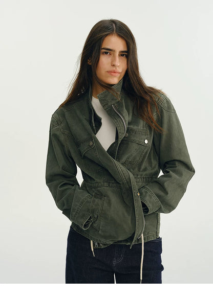 Army green field jacket with the waist drawstring pulled in to define the waist