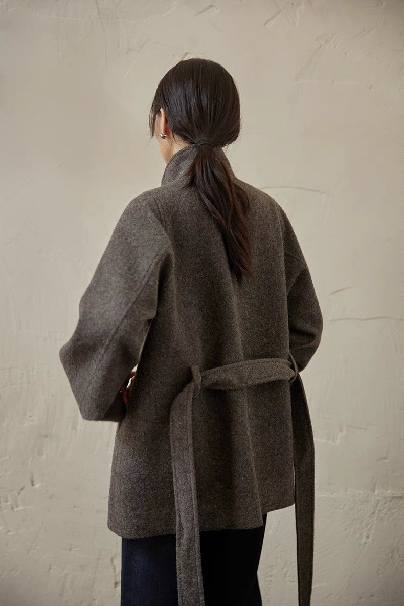 Gray wool belted jacket back view showing clean structure, back vent and tied waist belt