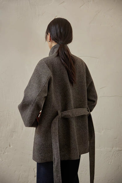 Gray wool belted jacket back view showing clean structure, back vent and tied waist belt