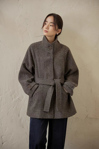 Gray wool belted jacket front portrait view highlighting stand collar and soft brushed texture
