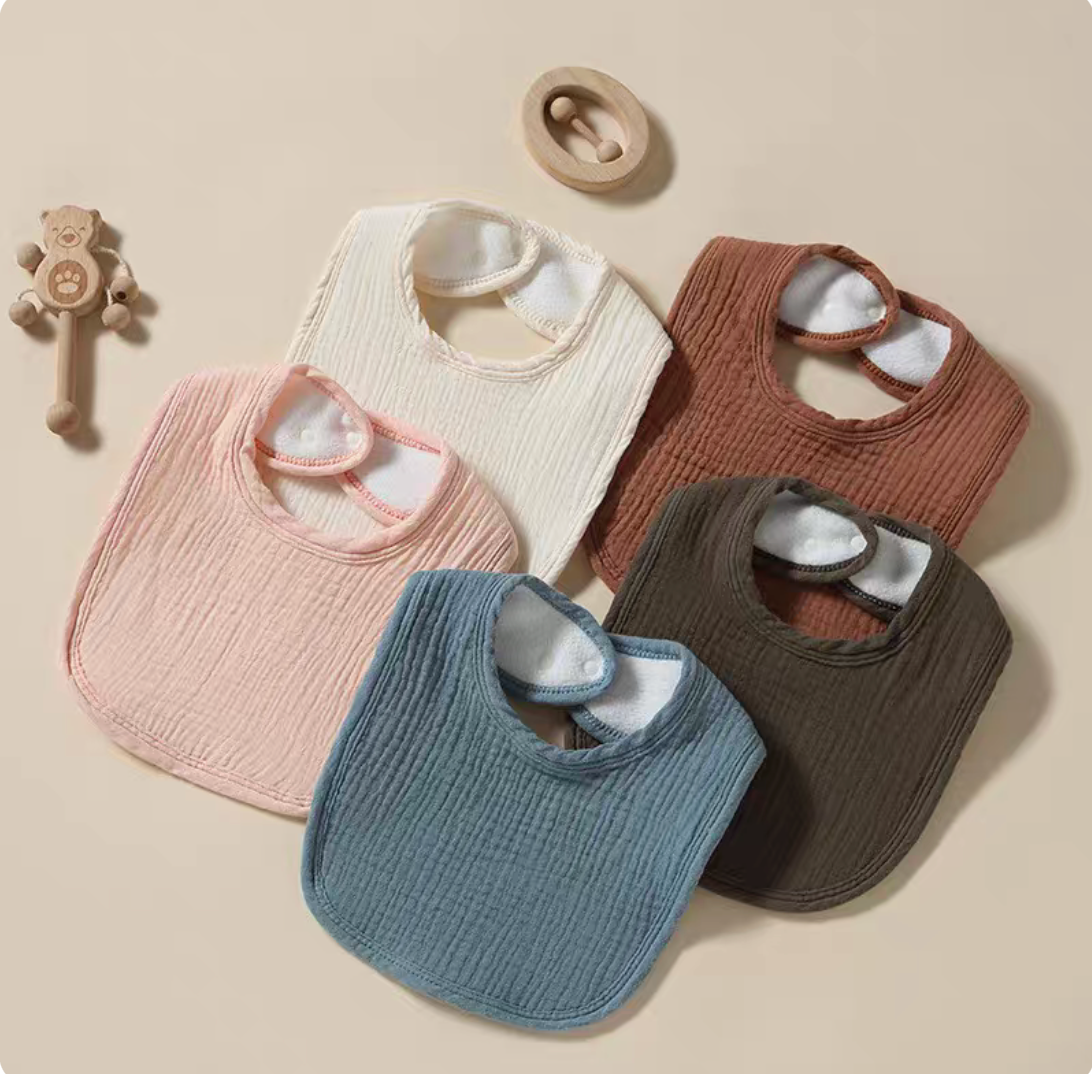 Baby cotton gauze bibs 2pcs set in multiple colors including green, pink, cream, blue and brown displayed together