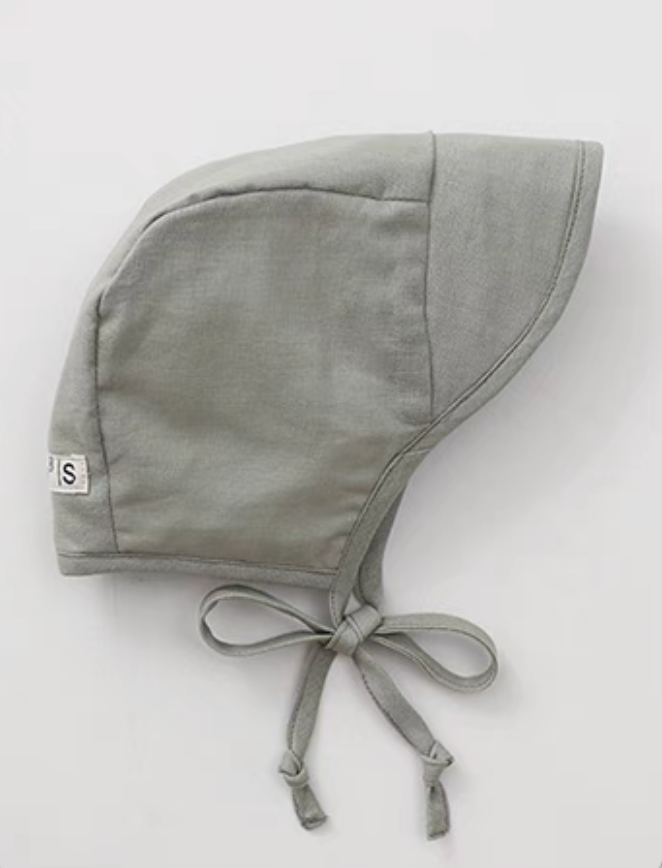 Sage green baby linen cotton sun hat side view with tie straps and soft structured brim