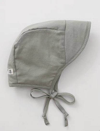Sage green baby linen cotton sun hat side view with tie straps and soft structured brim